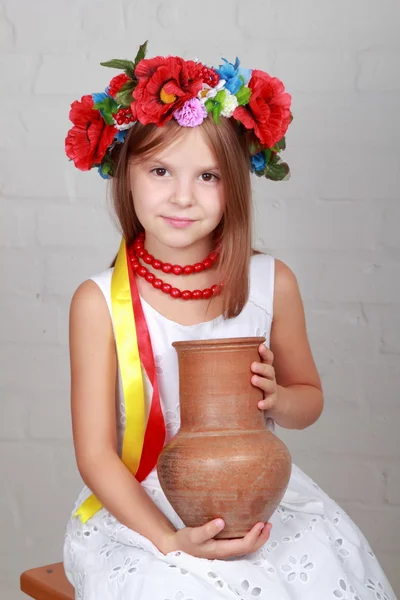 Ukrainian child in a suit holding a pitcher — Stock Photo, Image