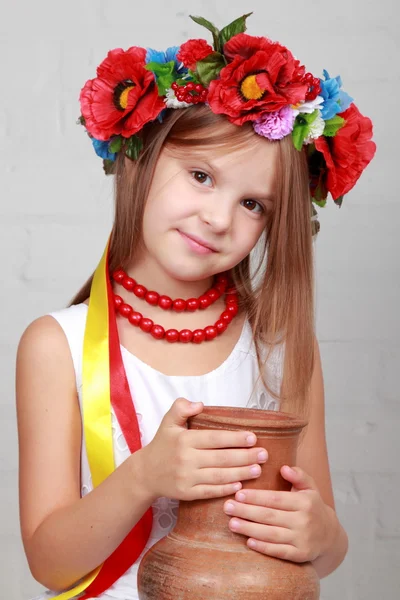 Ukrainian child in a suit holding a pitcher — Stock Photo, Image