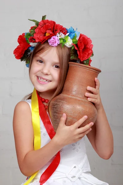 Ukrainian child in a suit holding a pitcher — Stock Photo, Image