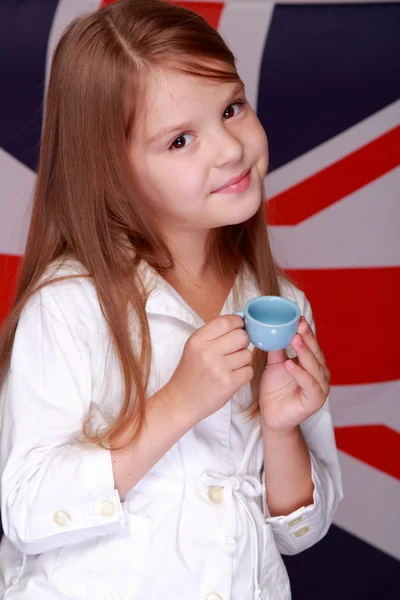 Little girl on the background of the flag of UK — Stock Photo, Image
