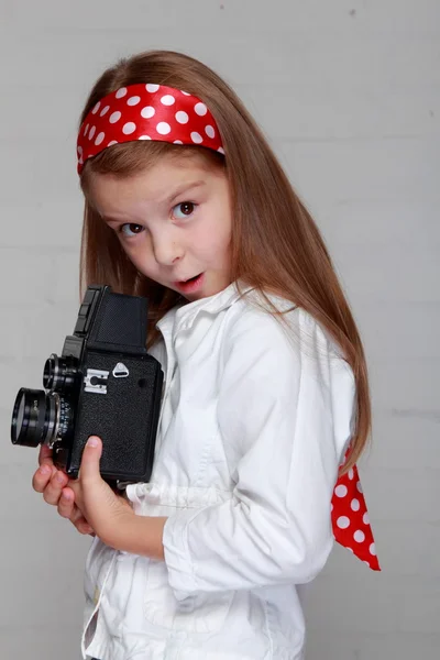 Girl holds a vintage camera — Stock Photo, Image