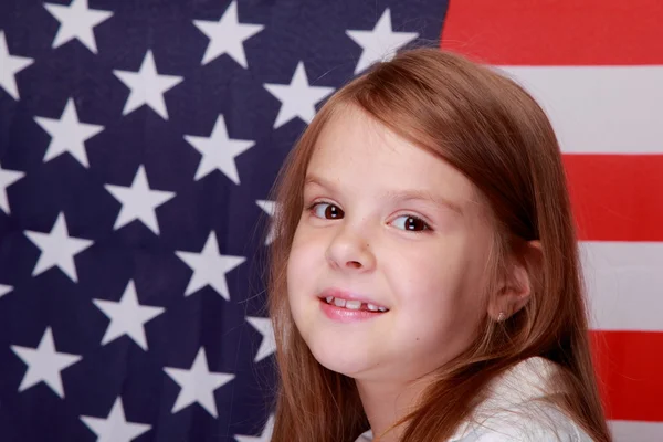 Girl against the background of the American flag — Stock Photo, Image