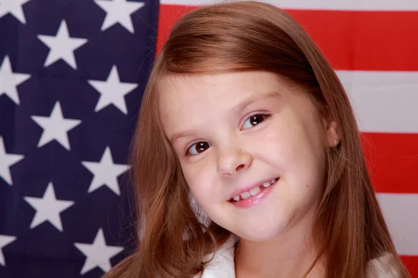 Girl against the background of the American flag — Stock Photo, Image