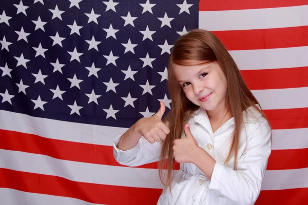 Girl against the background of the American flag — Stock Photo, Image