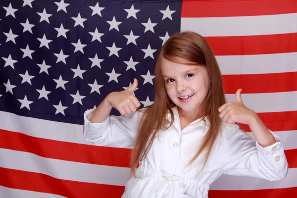 Girl against the background of the American flag — Stock Photo, Image