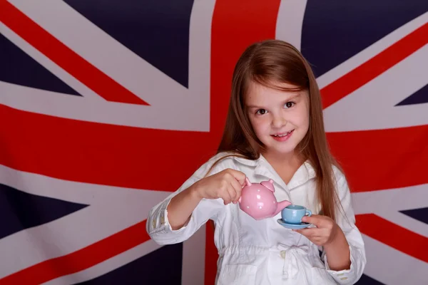 Girl on a background of the flag UK — Stock Photo, Image