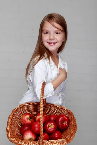 Meisje bedrijf mand met appelen — Stockfoto