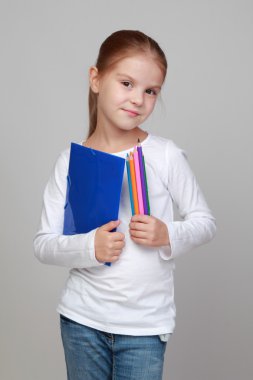 bir klasör ve renkli kalem tutan kız