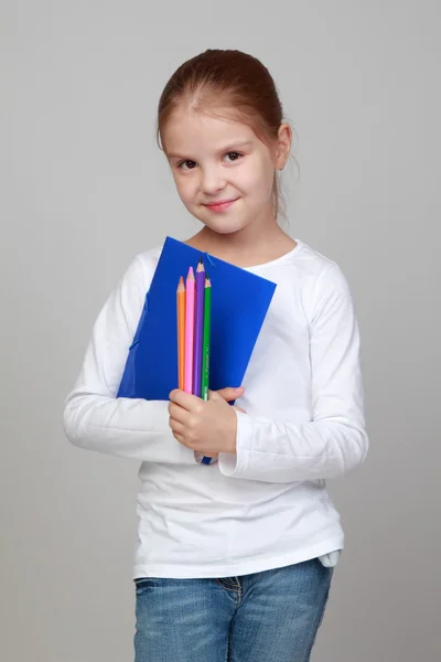 Mädchen hält Ordner und Bleistifte in der Hand — Stockfoto