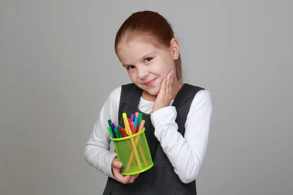 Cute schoolgirl holds a pencils — Stock Photo, Image