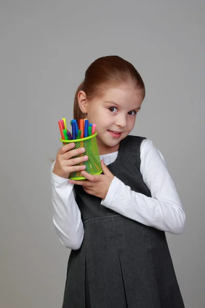 Cute schoolgirl holds a pencils — Stock Photo, Image