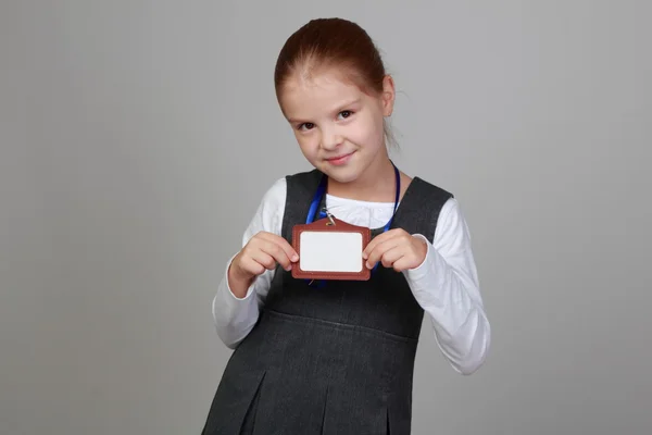 Little girl with a blank name tag — Stock Photo, Image