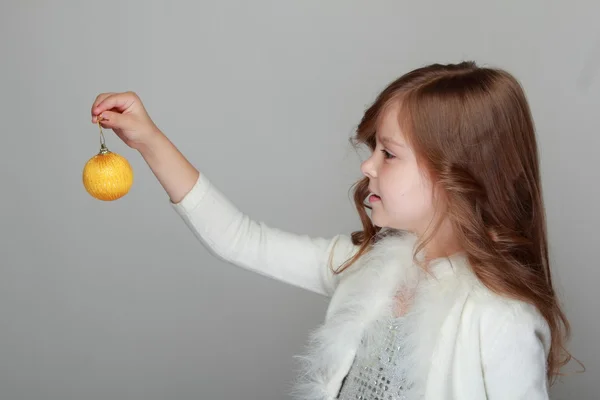 Girl holding a Christmas decoration — Stock Photo, Image