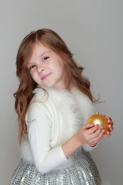 Girl holding a Christmas decoration — Stock Photo, Image