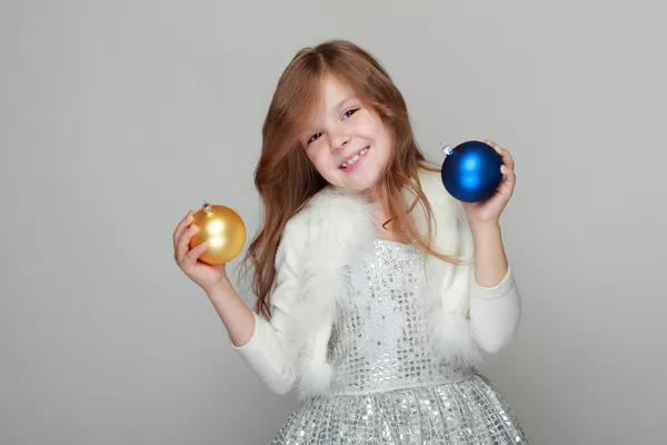 Girl holding a Christmas decoration — Stock Photo, Image