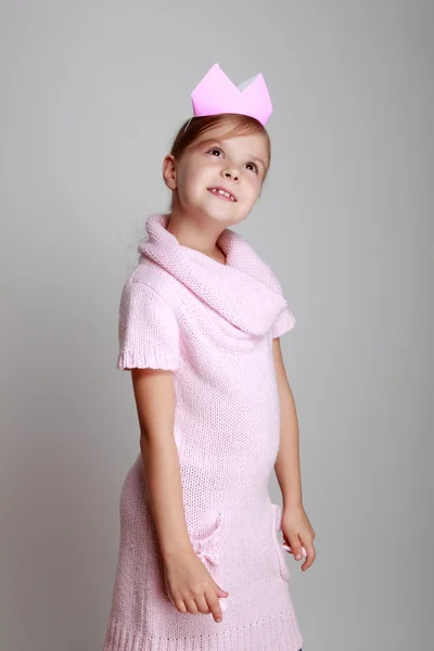 Child in a pink knitted dress with a pink crown — Stock Photo, Image