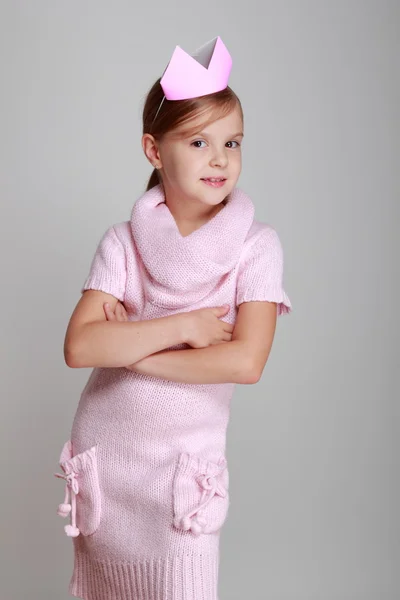 Child in a pink knitted dress with a pink crown — Stock Photo, Image