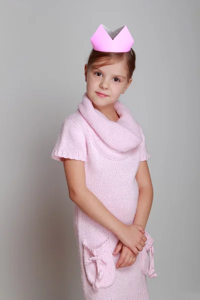 Child in a pink knitted dress with a pink crown — Stock Photo, Image