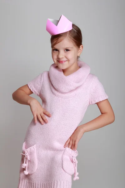 Child in a pink knitted dress with a pink crown — Stock Photo, Image