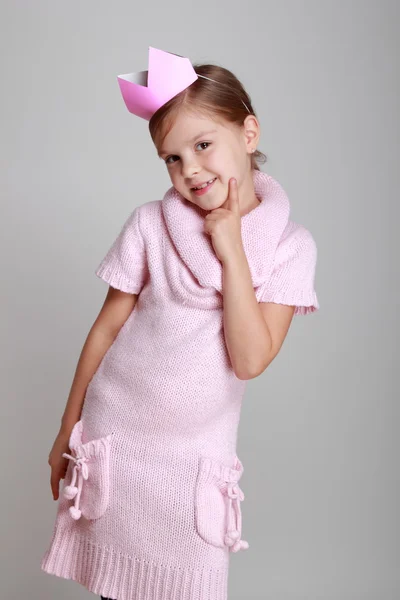 Girl in a pink knitted dress with a crown — Stock Photo, Image