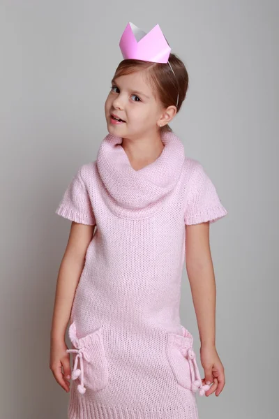 Child in a pink knitted dress with a pink crown — Stock Photo, Image