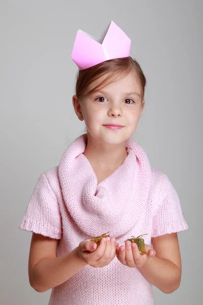 Girl in a pink knitted dress with a crown — Stock Photo, Image