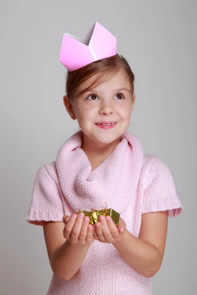 Child in a pink knitted dress with a pink crown — Stock Photo, Image