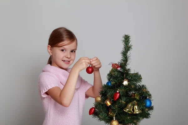 Girl near a Christmas tree Royalty Free Stock Photos