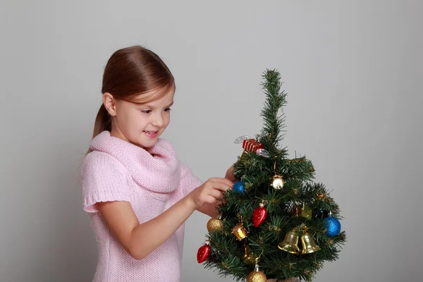 Child near a decorated Christmas tree Stock Photo