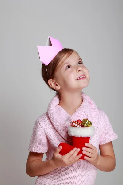 Llittle girl holding Christmas decoration in hand — Stock Photo, Image