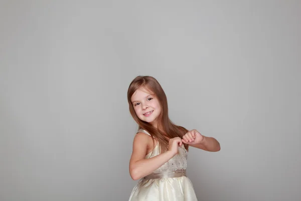 Menina dançando em um fundo cinza — Fotografia de Stock