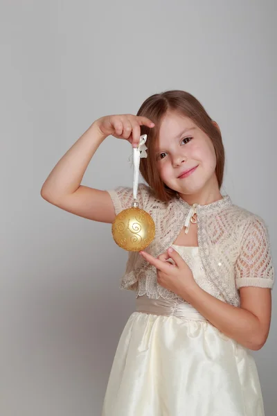 Chica sosteniendo un globo amarillo de Navidad — Foto de Stock