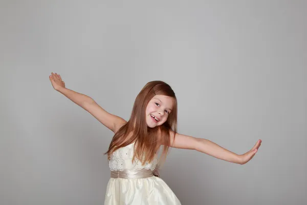 Girl having fun on a gray background — Stock Photo, Image