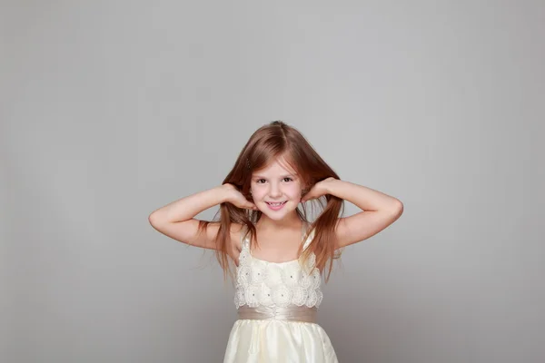 Girl having fun on a gray background — Stock Photo, Image