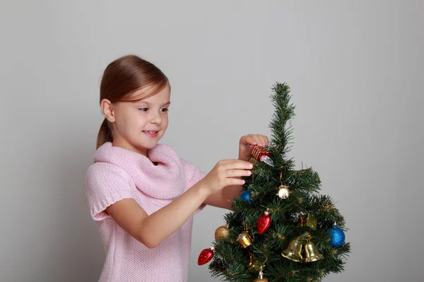 Smiling girl near a Christmas tree Stock Photo