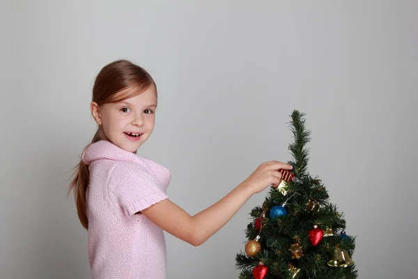 Child near a decorated Christmas tree Stock Photo