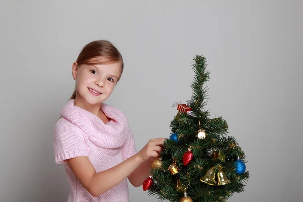 Smiling girl near a Christmas tree Stock Image