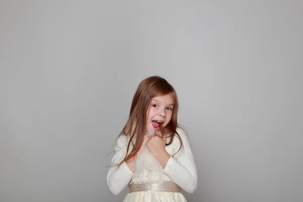 Girl having fun on a gray background — Stock Photo, Image