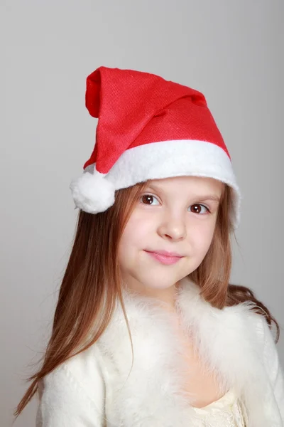 Little girl in Santa hat Stock Photo