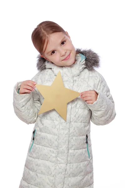 Girl in winter clothes with a gold star — Stock Photo, Image