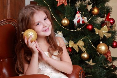 Young princess holding decorative golden ball