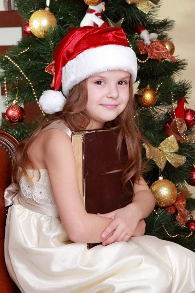 Girl reading book around Christmas — Stock Photo, Image