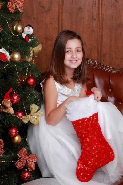 Little girl found a Christmas present in sock — Stock Photo, Image