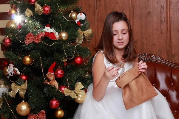 Little girl with present golden sack — Stock Photo, Image