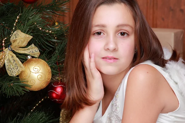 Little girl over Christmas tree Stock Image