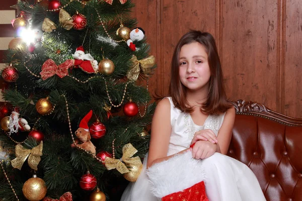 Little girl over Christmas tree Stock Picture