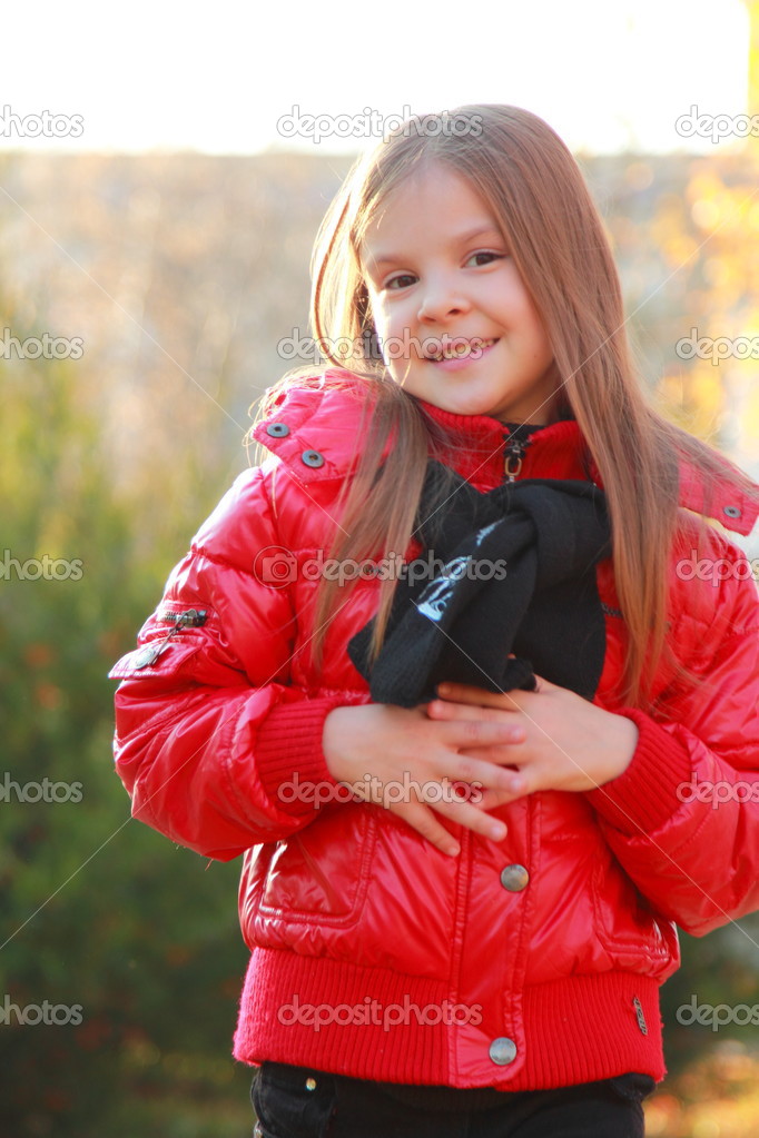 Little girl with maple leaves
