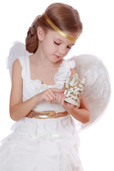 Little angel with toy tiny house Royalty Free Stock Photos