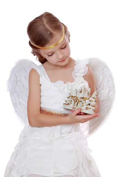 Little angel with toy tiny house Royalty Free Stock Images