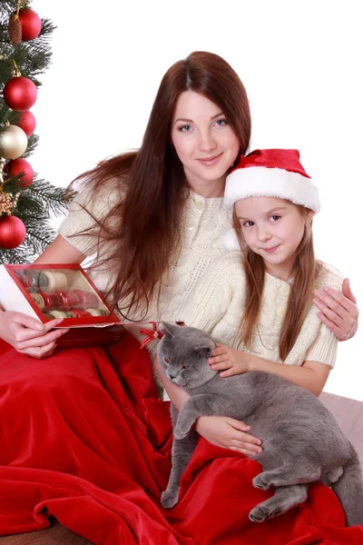 Mother and daughter holding over Christmas tree — Stock Photo, Image